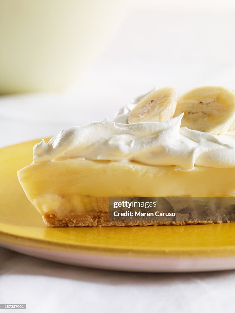 Slice of Banana Cream Pie on Yellow Plate