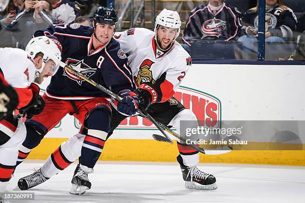 Brandon Dubinsky of the Columbus Blue Jackets and Jaren Cowen of the Ottawa Senators battle for position on November 5, 2013 at Nationwide Arena in...