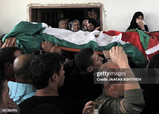 Palestinian relatives mourn during the funeral of Bashir Habaneen in the West Bank village of Mirka near Jenin on November 8, 2013 after Israeli...
