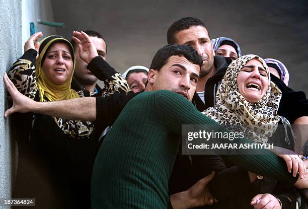 Palestinian relatives mourn during the funeral of Bashir Habaneen in the West Bank village of Mirka near Jenin on November 8, 2013 after Israeli...