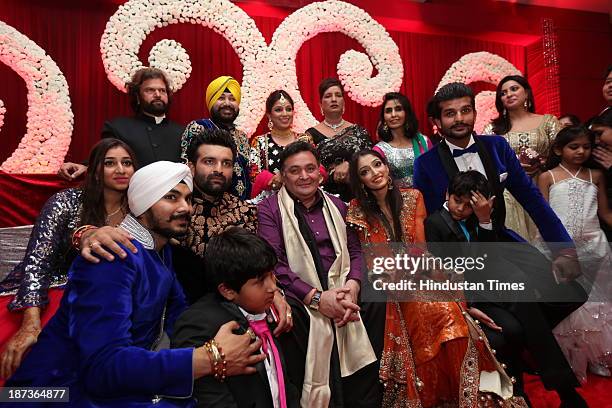 Bollywood actor Rishi Kapoor poses with wedding couple Daler Mehndis daughter Ajit Kaur and Navraj Singh, son of singer Hans Raj Hans and their...