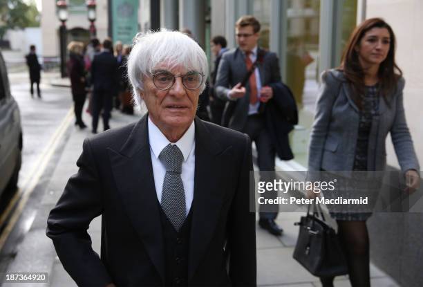 Formula One boss Bernie Ecclestone makes an unexpected departure from court with his wife Fabiana Flosi after a fire alarm cleared the Rolls Building...