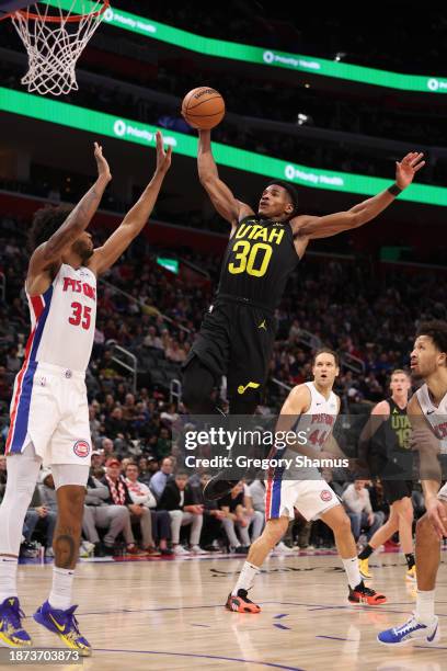 Ochai Agbaji of the Utah Jazz drives to the basket against Marvin Bagley III of the Detroit Pistons during the second half at Little Caesars Arena on...