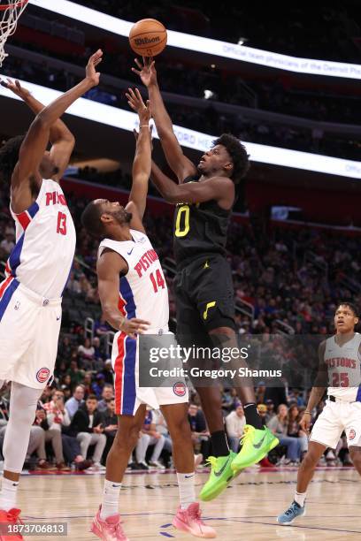 Taylor Hendricks of the Utah Jazz takes a second half shot over Alec Burks of the Detroit Pistons during the second half at Little Caesars Arena on...