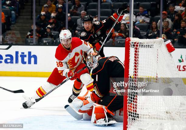 Elias Lindholm of the Calgary Flames takes a shot against Lukas Dostal of the Anaheim Ducks in the first period at Honda Center on December 21, 2023...