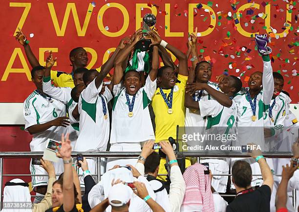 Akinjide Idowu of Nigeria and his team-mates celebrate their victory with the trophy during the FIFA World Cup UAE 2013 Final between Nigeria and...