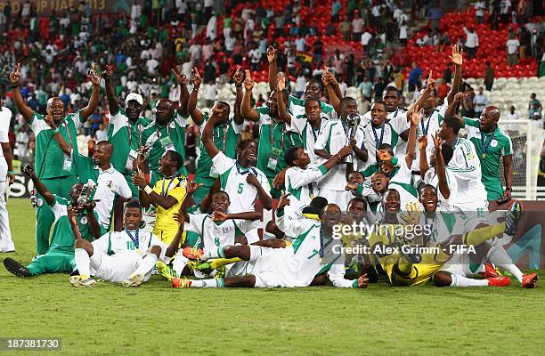 The Nigeria team celebrate their victory with their trophies after the FIFA World Cup UAE 2013 Final between Nigeria and Mexico at Mohamed Bin Zayed...