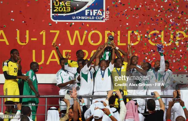 Akinjide Idowu of Nigeria and his team-mates celebrate their victory with the trophy after the FIFA U-17 World Cup UAE 2013 Final between Nigeria and...
