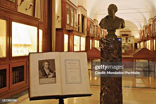 Italy, Emilia-Romagna, Parma, Palazzo della Pilotta, Interior view of a room with a book, a bust and some documents in the caskets,