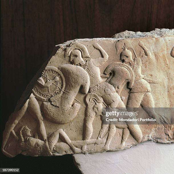 Italy, Basilicata, Metaponto, Antiquarium, Detail, An earthenware fragment representing, in bas-relief, a battle scene between greek warriors, armed...