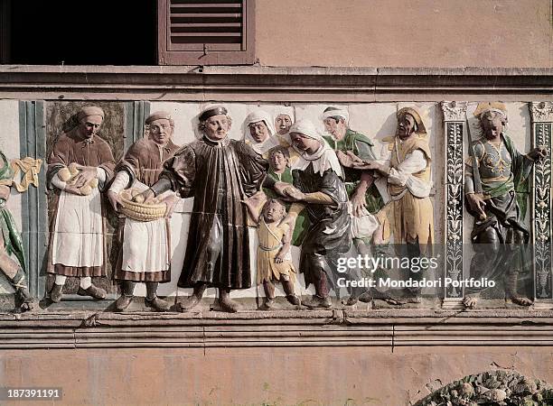 Italy, Tuscany, Pistoia, Ospedale del Ceppo, Detail, Decorative frieze depicting a well-to-do man making good deeds: with his attendants' help, he...