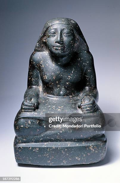 Private collection, All, Frontal view, Seated scribe with crossed legs and a papyrus scroll on them,