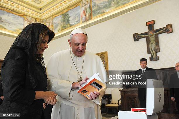 Pope Francis exchanges gifts with Costa Rica President Laura Chinchilla during a private meeting at his private library on November 8, 2013 in...