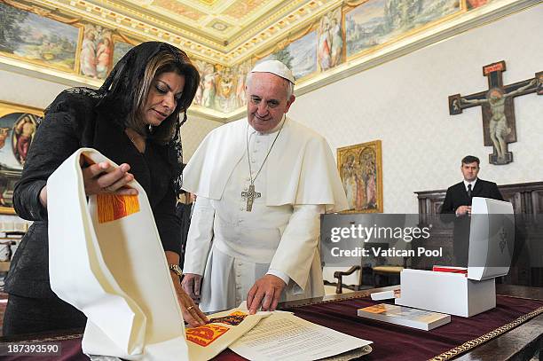 Pope Francis exchanges gifts with Costa Rica President Laura Chinchilla during a private meeting at his private library on November 8, 2013 in...