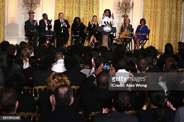 First lady Michelle Obama speaks as director David Frankel, director Ryan Coogler, production executive Harvey Weinstein, actress Whoopi Goldberg,...