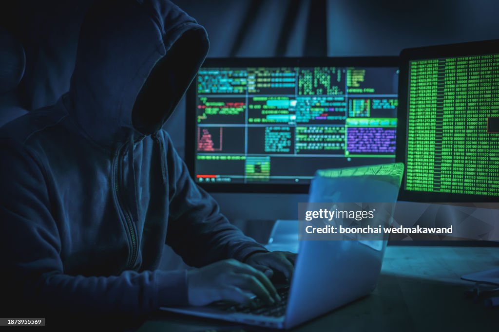 Wanted hackers coding virus ransomware using laptops and computers.