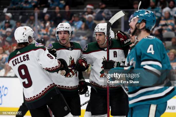 Nick Schmaltz of the Arizona Coyotes is congratulated by Sean Durzi and Clayton Keller after he scored a goal against the San Jose Sharks in the...