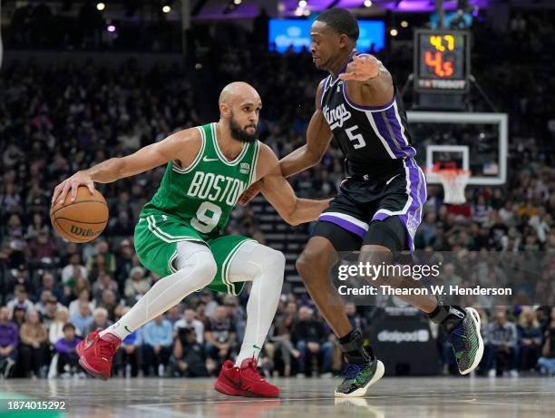 Derrick White of the Boston Celtics dribbling the ball while guarded by De'Aaron Fox of the Sacramento Kings during the first half of an NBA...
