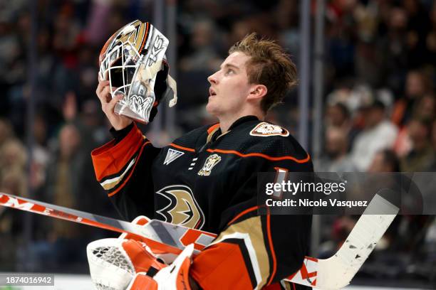 Lukas Dostal of the Anaheim Ducks adjusts his goalie mask in the second period during the game against the Calgary Flames at Honda Center on December...