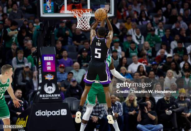 De'Aaron Fox of the Sacramento Kings shoots over Jaylen Brown of the Boston Celtics during the first half of an NBA basketball game at Golden 1...