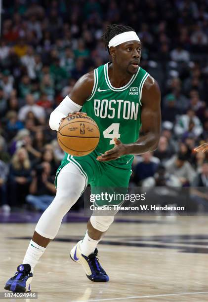 Jrue Holiday of the Boston Celtics dribbling the ball looks to drive to the basket against the Sacramento Kings during the first half of an NBA...