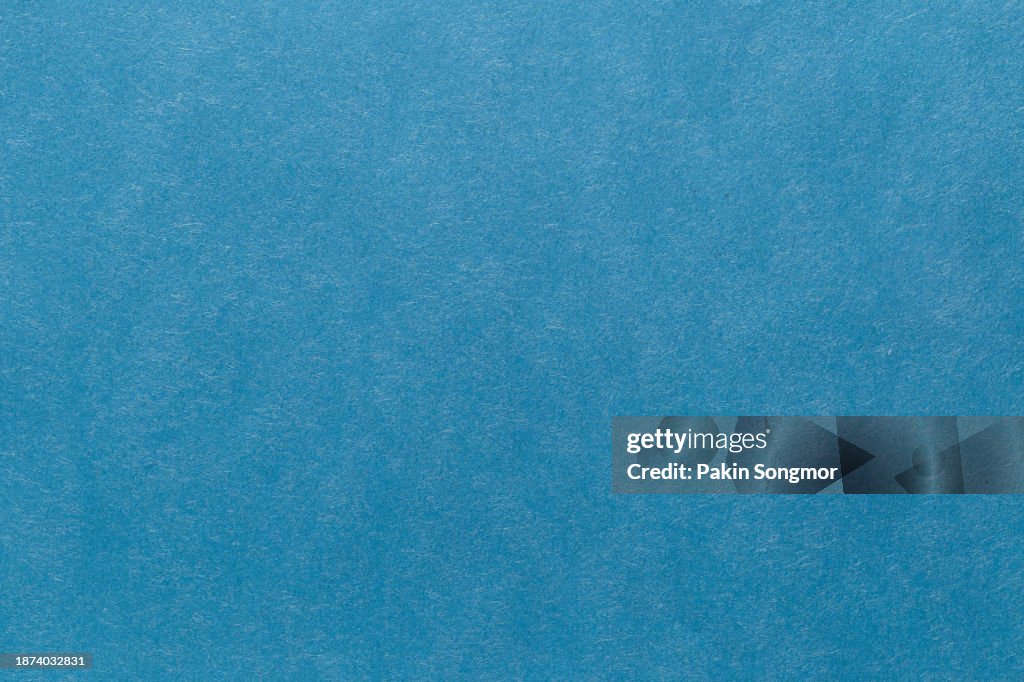 Blue color paper sheet texture cardboard background.