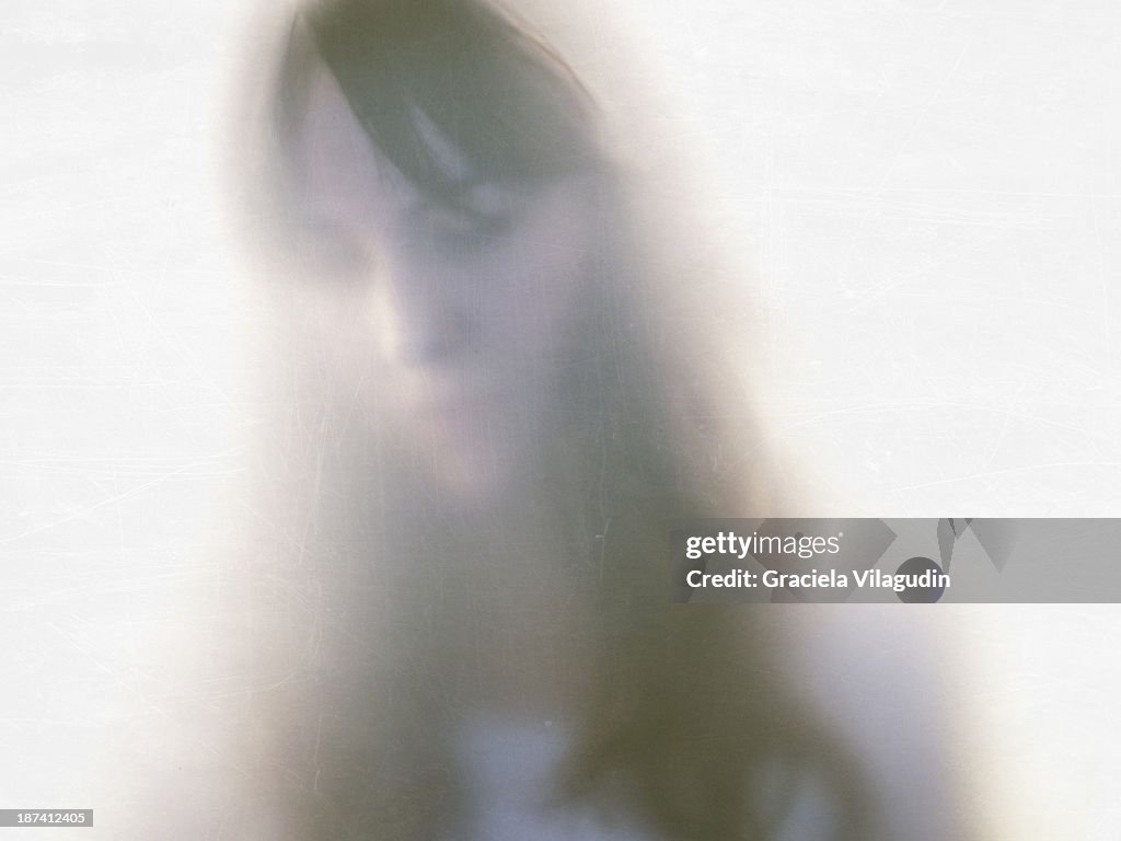 Girl trought opaque glass with scratches