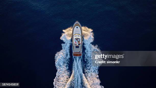 yacht cruising fast in sea - yacht top view stock pictures, royalty-free photos & images