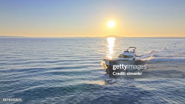 couple sailing yacht over ocean - distant stock pictures, royalty-free photos & images