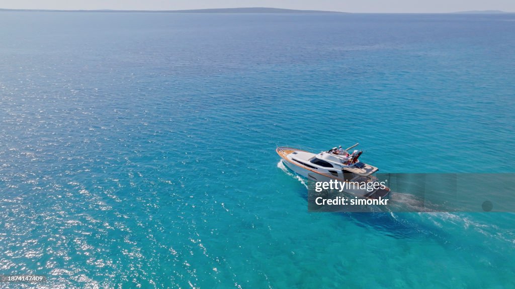 Yacht cruising fast in sea