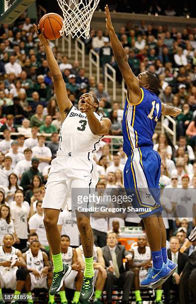 Alvin Ellis III of the Michigan State Spartans gets to the basket in the second half past Kevin Hardy of the McNeese State Cowboys at the Jack T....