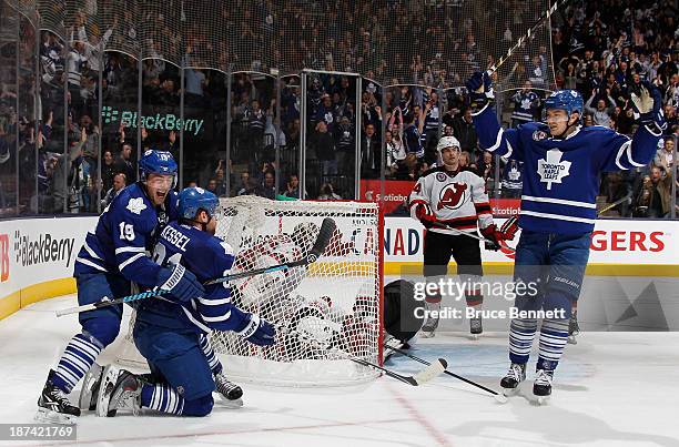 Phil Kessel of the Toronto Maple Leafs celebrates his power play goal at 8:12 of the third period against the New Jersey Devils and is joined by...