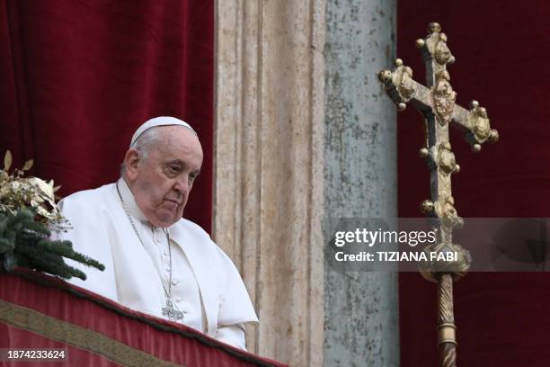 Pope Francis stands at the balcony of St. Peter's basilica to deliver the Christmas Urbi et Orbi blessing in St. Peter's Square at The Vatican on...