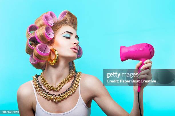 glamorous woman blow drying her curled hair - hair dryer stock pictures, royalty-free photos & images