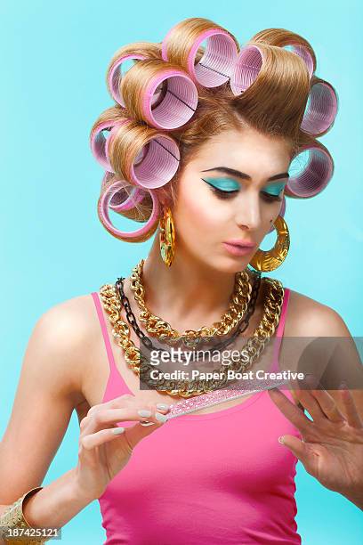 glamorous woman in a beauty salon filing her nails - guldkedja bildbanksfoton och bilder