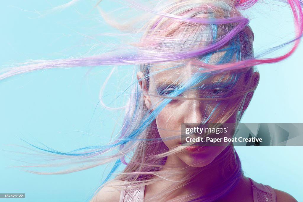 Lady with colorful hair flying across her face