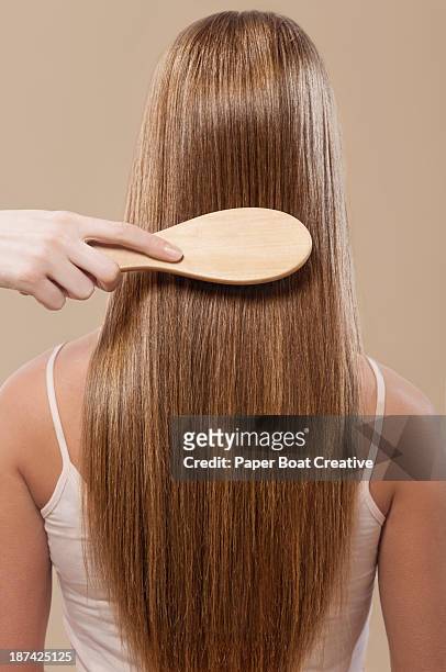 close up of hair brushing straight brown hair - straight hair 個照片及圖片檔