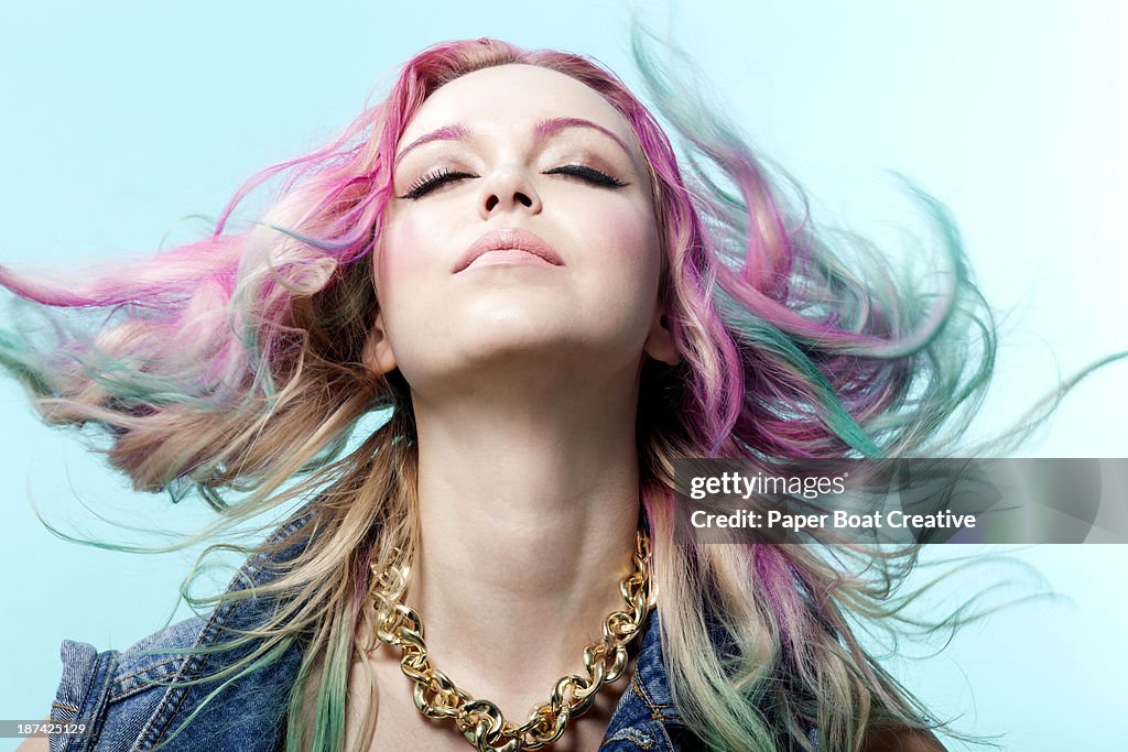 Lady with multiple colored dyed hair, eyes closed