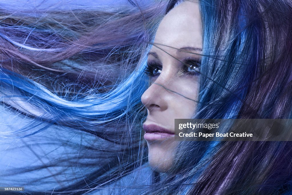 Lady with blue and purple hair flowing in front