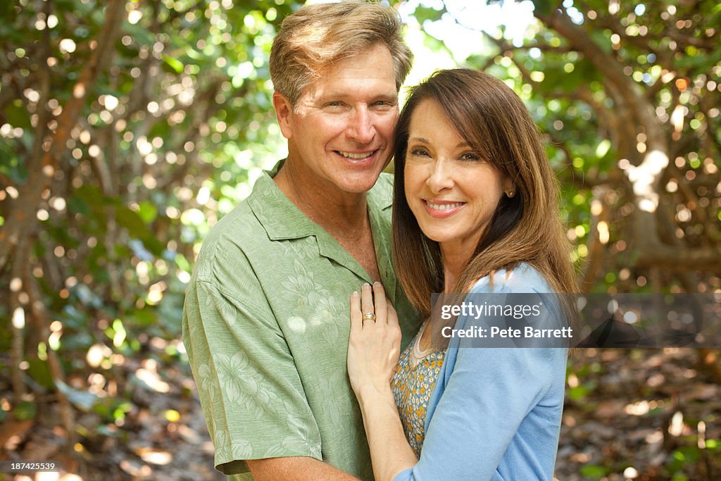 Middle aged couple together pathway in woods