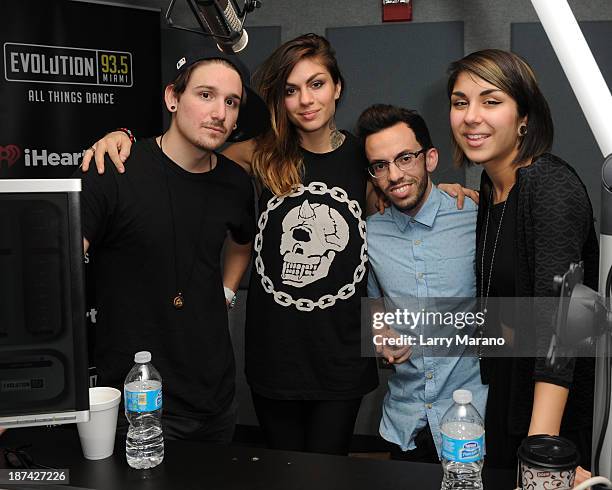 Yasmine Yousaf, Kris Trindl and Jahan Yousaf of Krewella pose with DJ Obscene at Y 100 radio station on November 8, 2013 in Miami, Florida.