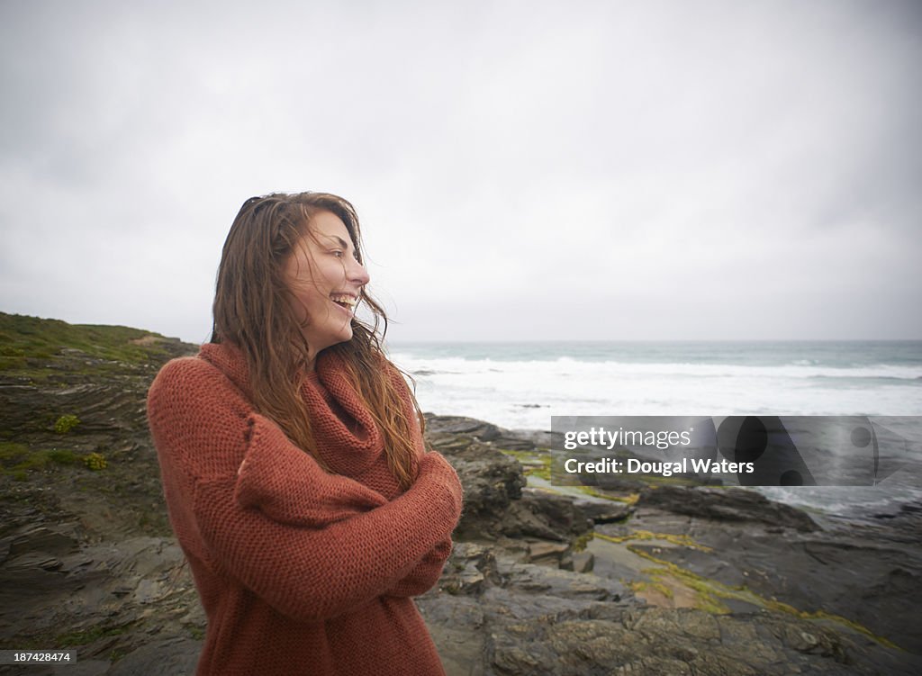Woman laughing on Atlantic coastline.