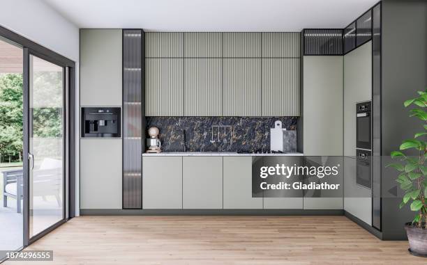 moderne khakigrüne küche mit platz (für eine insel oder einen tisch) auf den parkettböden und einer großen offenen fenstertür mit gartenblick an der seite - herde stock-fotos und bilder