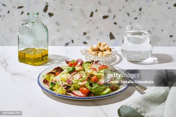 vegan vegetarian salad - cherry tomato, cucumber, radish, lettuce - cashew pieces stock pictures, royalty-free photos & images