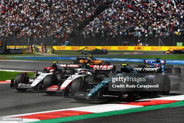 Yuki Tsunoda of Japan driving the Scuderia AlphaTauri AT04, Kevin Magnussen of Denmark driving the Haas F1 VF-23 Ferrari and Fernando Alonso of Spain...
