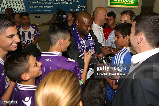 New Perth Glory A-League recruit William Gallas stops to sign autographs for Glory supporters after arriving at Perth International Airport on...