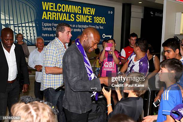 New Perth Glory A-League recruit William Gallas stops to sign autographs for Glory supporters after arriving at Perth International Airport on...