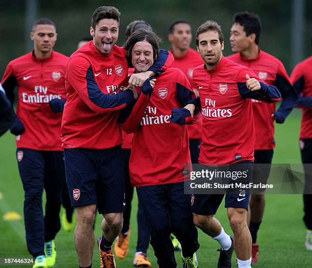 Olivier Giroud, Tomas Rosicky and Mathieu Flamini of Arsenal in action during the Arsenal Training Session at London Colney on November 9, 2013 in St...