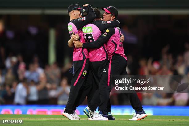 Moises Henriques of the Sixers and team mates celebrate winning the BBL match between Sydney Sixers and Adelaide Strikers at Sydney Cricket Ground,...