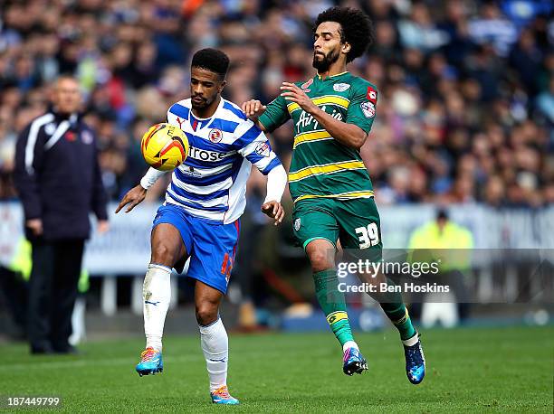 Gareth McCleary of Reading holds off pressure from Benoit Assou-Ekotto of QPR during the Sky Bet Championship match between Reading and Queens Park...